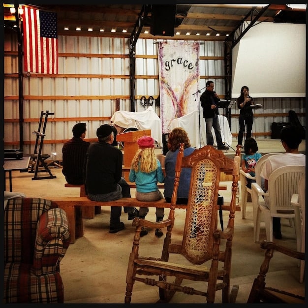 A behind-the-scenes shot of a comedy movie set, showing the director giving instructions to the actors and crew, with various comedic props and set pieces in the background.