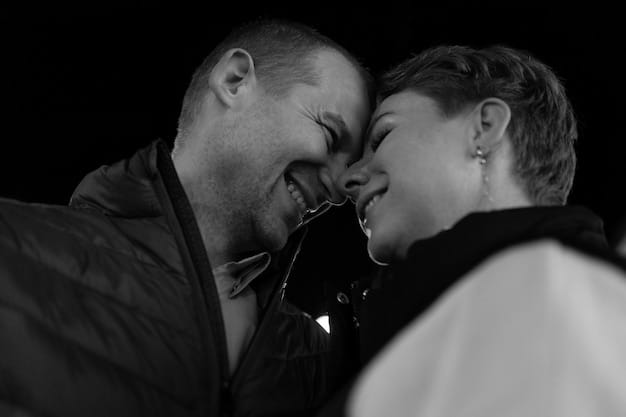 A black and white photograph from a romance film set, capturing the intense gaze and emotion between two actors in a close-up shot.