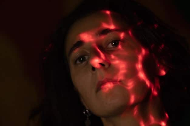 A close-up shot of a woman's face, her eyes wide with terror, reflecting the flickering light of a screen. Her expression conveys intense fear and vulnerability.