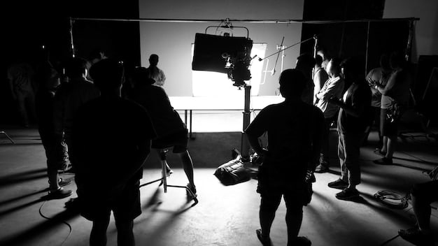 A director on a film set, passionately explaining a scene to the actors, surrounded by cameras and crew members. The lighting is cinematic.
