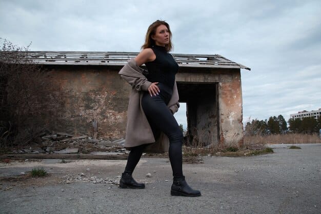 A striking image of a woman standing defiantly in a dusty, deserted town street, holding a rifle, symbolizing her determination for revenge in the film Dakota's Revenge.